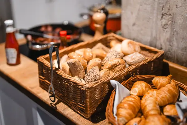 Manden met brood en croissants op een toonbank