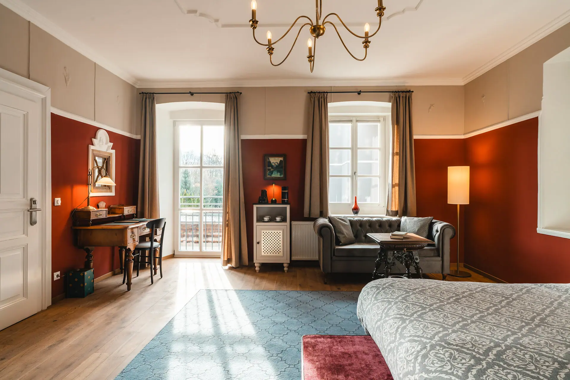 HENRI Kitzbühel Hotelkamers Een kamer met een bank en een bureau.