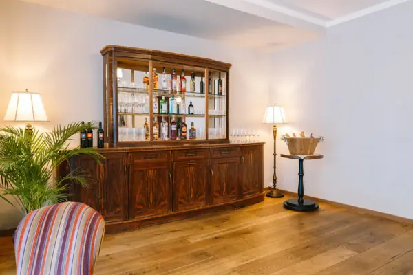 Een kamer met een kledingkast, een tafel en stoelen.