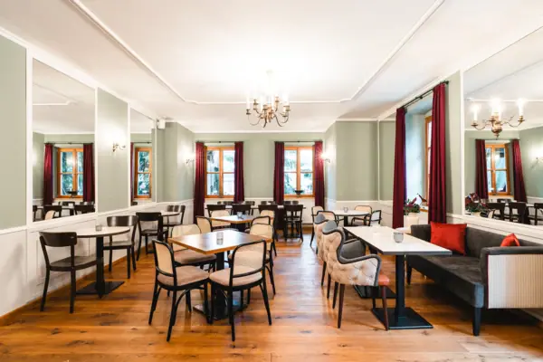 Een kamer met tafels en stoelen.