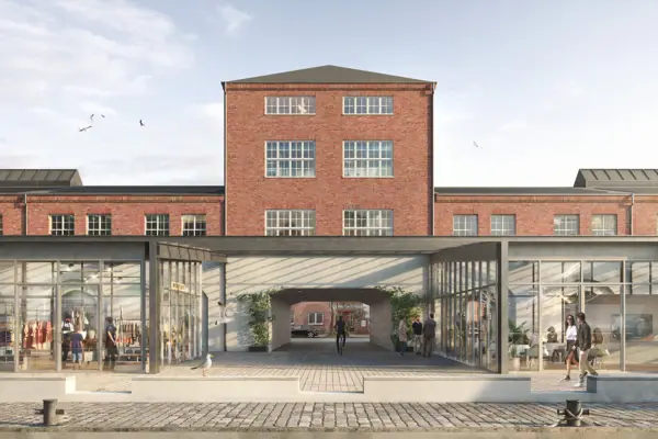 Een gebouw met glazen deuren en ramen onder een bewolkte hemel.