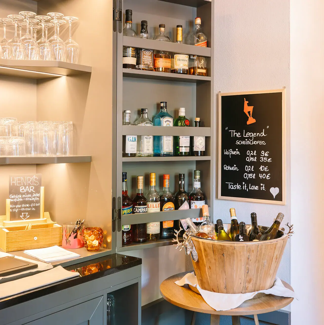 HENRI Bar Een plank met flessen alcohol.