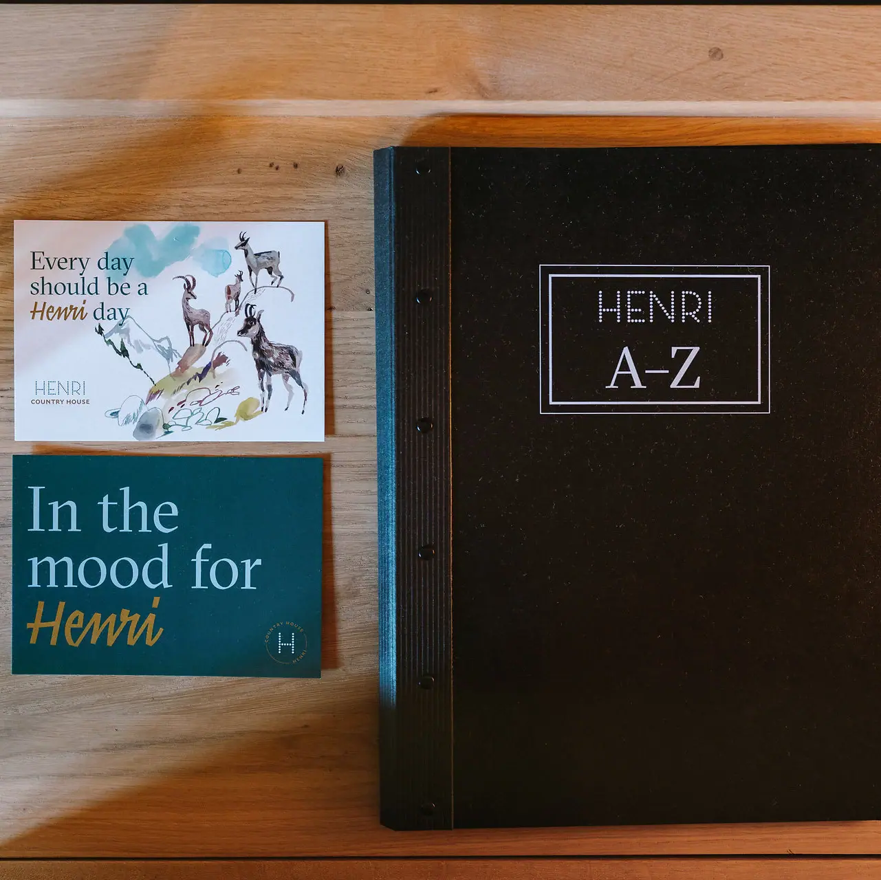 Een boek en een visitekaartje op een tafel.