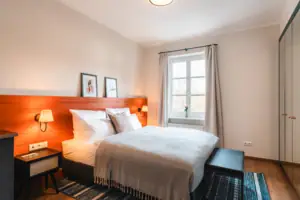 Bed Bed met houten hoofdeinde en lamp in de slaapkamer.