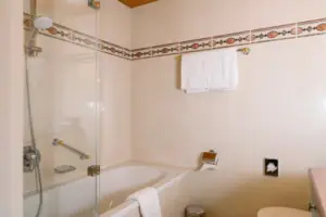 Badkamer in het HENRI in Garmisch-Partenkirchen Badkamer met douche met glazen deur en moderne kranen.