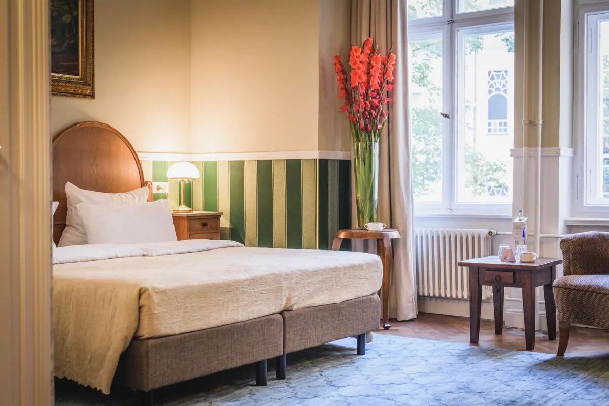 Kamer met bed en bloemenvaas