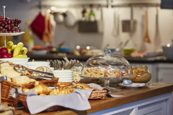Buffet met broodjes, croissants en fruit erop.