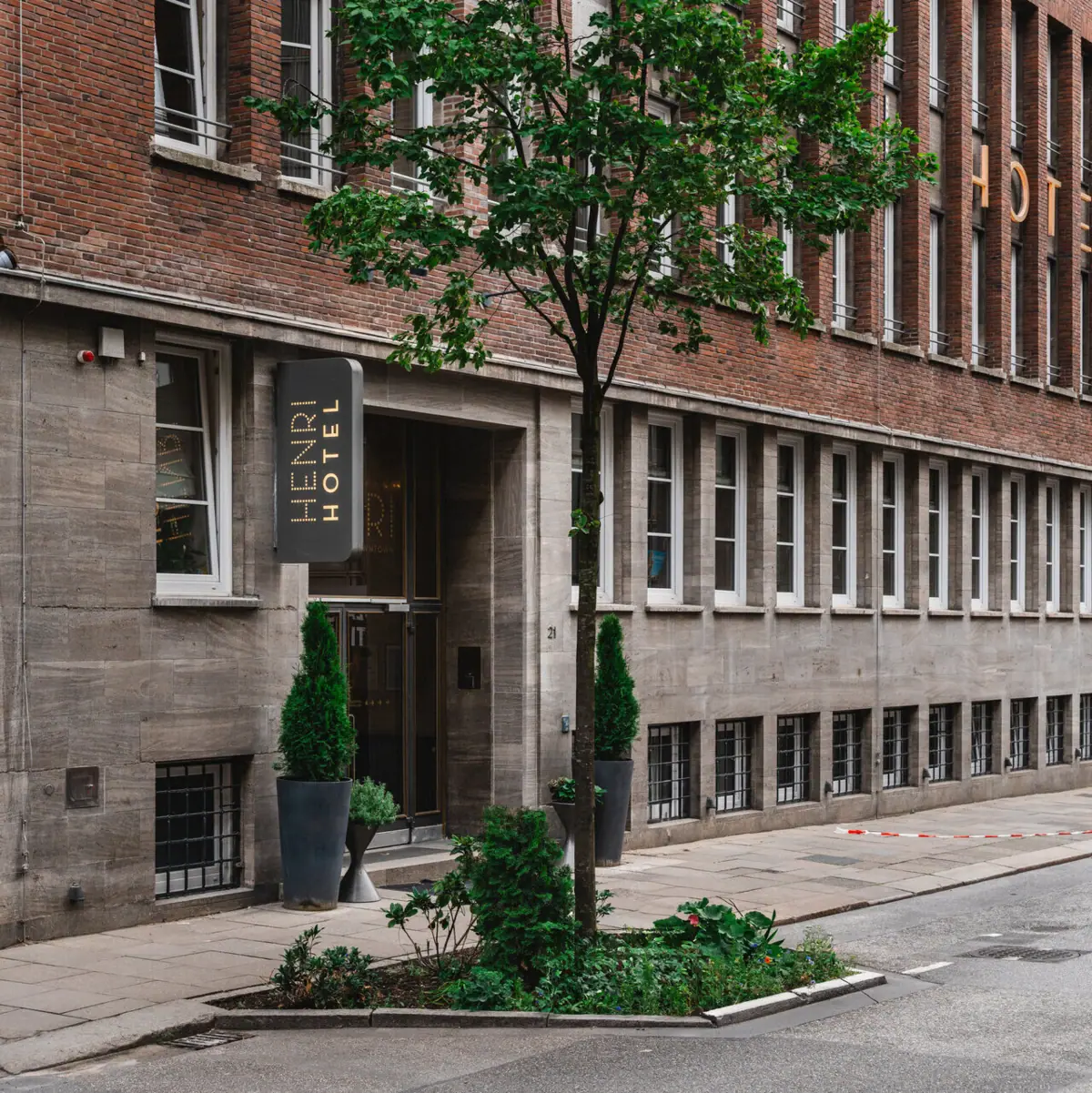 Een boom naast de ingang van het HENRI Hotel Hamburg.