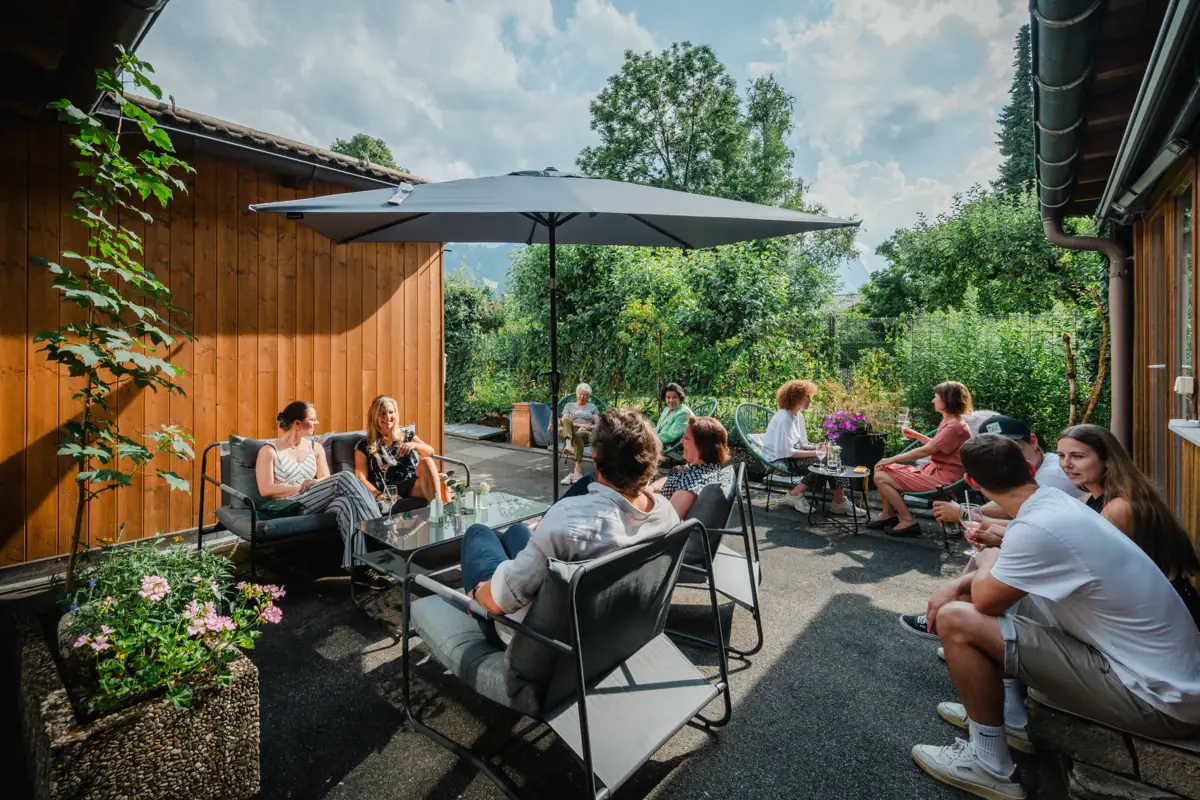 Een groep mensen zit buiten op een terras.