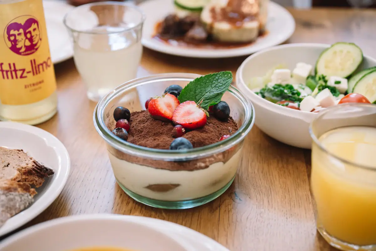 Schaal met dessert, gegarneerd met aardbeien en bosbessen.