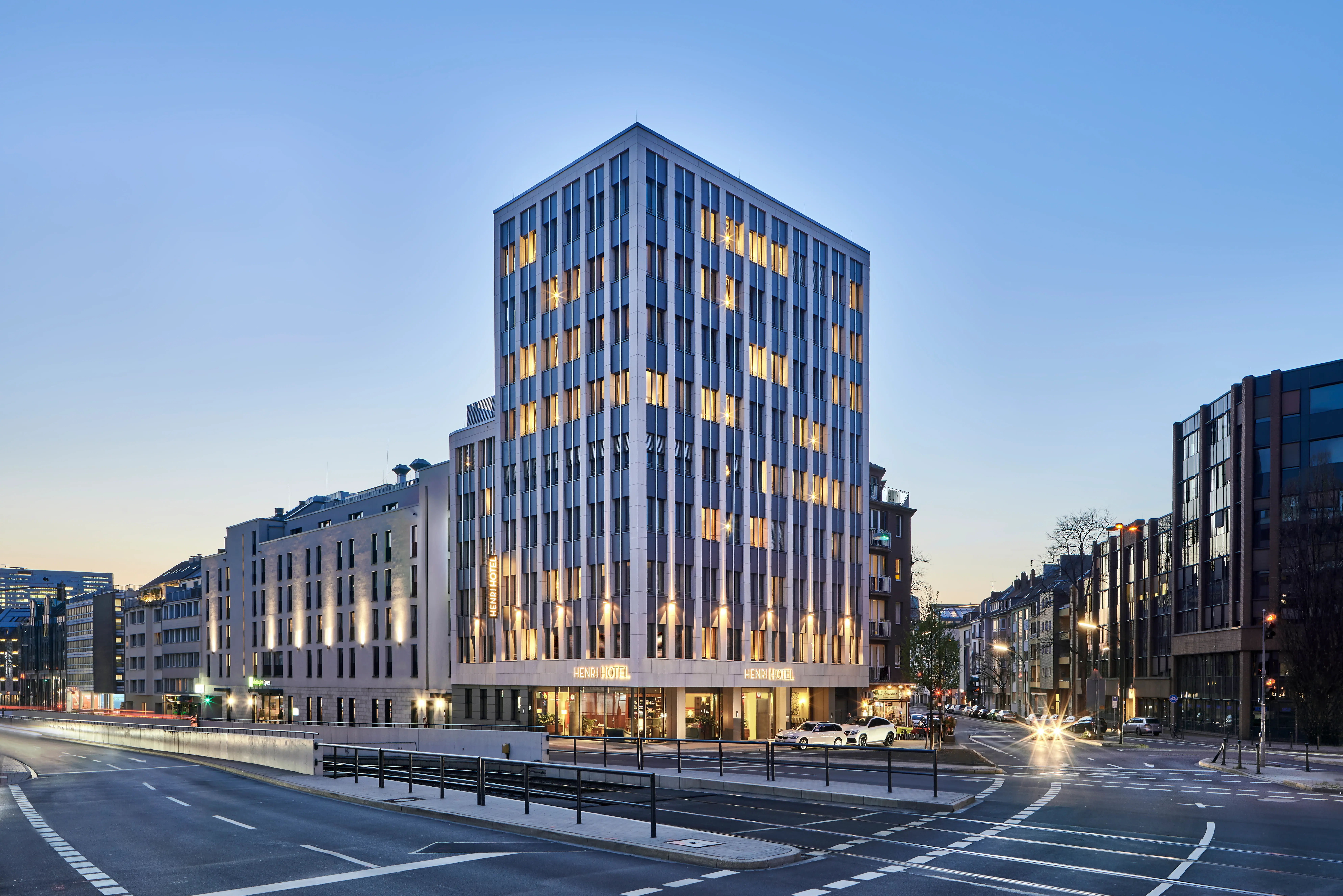 Een verlichte torenflat in een stedelijke omgeving bij nacht.