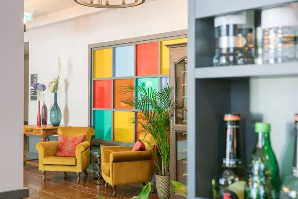 Een kamer met een kroonluchter en stoelen.